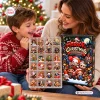 Close-up of a mother and child opening a Horror Christmas Advent Calendar Blind Box containing small spooky figurines.