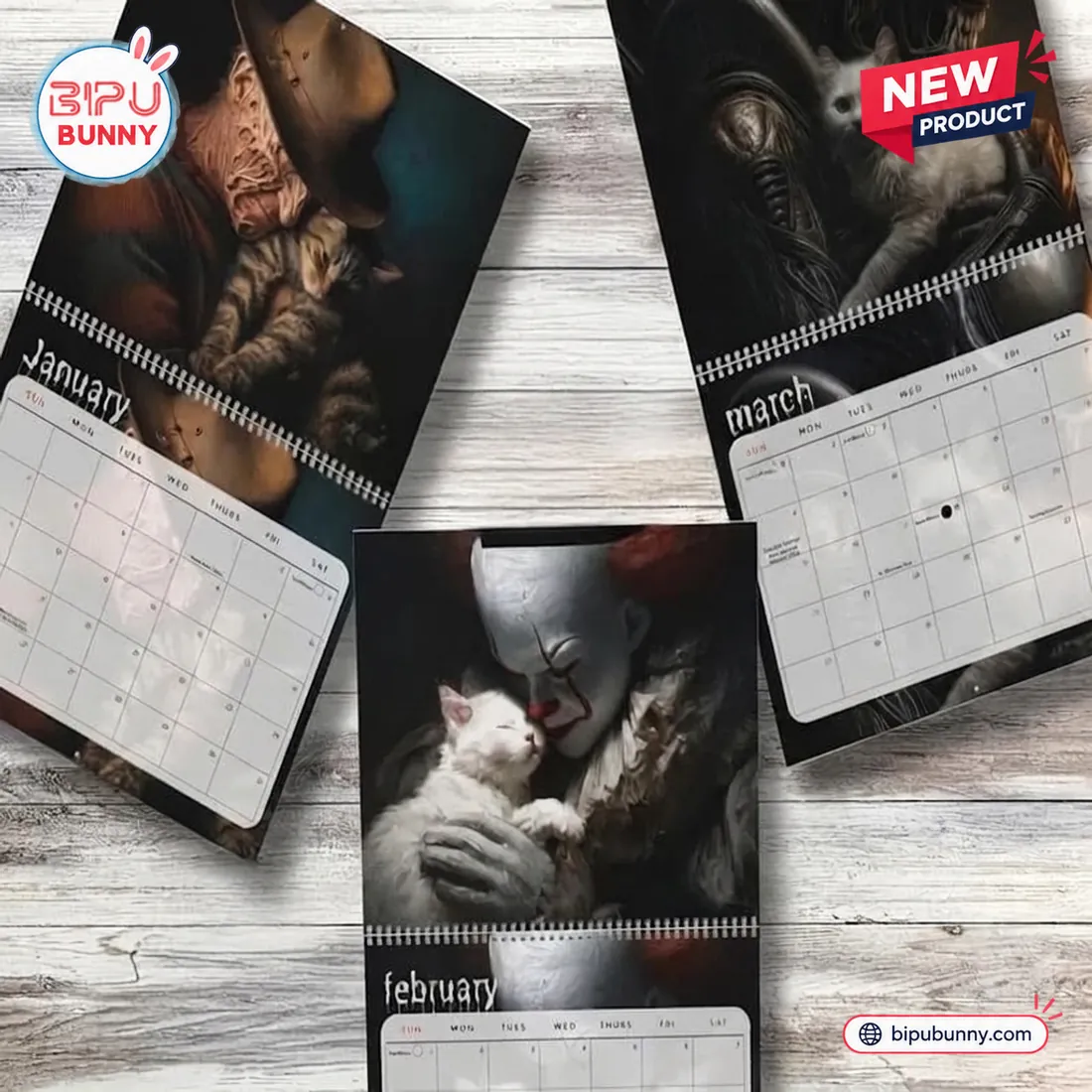 Top view of Horror Movie and Cats 2027 Wall Calendar pages laid on wood.