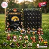 Front view of an Iowa Hawkeyes 2026 Christmas Advent Calendar with miniature figurines displayed on grass.
