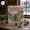 Front view of an It's Climbing Time mountaineering advent calendar box surrounded by miniature figures and climbing gear on a wooden table.