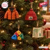 Close-up view of four mountaineering advent calendar ornaments hanging on a lit Christmas tree.