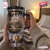 Hand holding a Jack Daniels 140th Anniversary YETI Handle Tumbler in a bedroom setting.