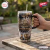 Hand holding a Jack Daniels 140th Anniversary YETI Handle Tumbler on a wooden table outdoors.