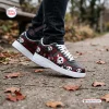 Lifestyle view of Jack Skellington Christmas Air Force 1 Shoes worn outdoors on a paved path with autumn leaves.
