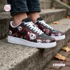 Side view of Jack Skellington Christmas Air Force 1 shoes worn outdoors on stone steps.