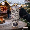 Hand holding a Jack Skellington Nightmare Before Christmas 40Oz Tumbler with Merry Jackmas holiday graphics outdoors.