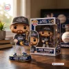 Front view of Jake Bauers 2026 NLCS MVP vinyl figure standing with a trophy next to its box.