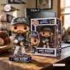 Front view of the Jake Bauers 2026 NLCS MVP Vinyl Figure standing next to its box on a wooden desk.