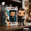 Front view of James Bond Dr. No vinyl figure standing beside its packaging box on a wooden desk.