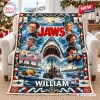 Front view of Jaws Movie Personalized Blanket draped on a chair with film montage graphics and custom text.
