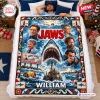 Lifestyle view of a Jaws Movie Personalized Blanket spread on a bed featuring a shark graphic and the name William.