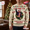 Front view of a cream holiday sweater featuring a person in a Santa hat surrounded by a festive wreath.