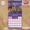 Front view of the K-Pop Demon Hunters 2027 Wall Calendar hanging on a wooden wall.