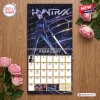 Front view of the K-Pop Demon Hunters 2027 Wall Calendar open to February on a wooden surface with pink roses.