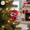 Close-up of a Kansas City Chiefs helmet ornament hanging on a lit Christmas tree.