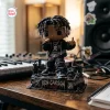 Front view of Ken Carson Chaos Vinyl Figurine holding a microphone on a detailed rubble base.