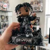 Close-up of Ken Carson Chaos Vinyl Figurine held in hand, featuring detailed dreadlocks and stage base.