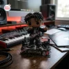 Front view of the Ken Carson Chaos Vinyl Figurine on a studio desk with a keyboard.
