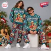 Model couple wearing Kenny Chesney No Shoes Nation Christmas sweatshirt and jogger set in a holiday setting.
