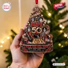Close-up of a hand holding a Kiss Rock Band 50th Anniversary Ornament shaped like a decorated tree.