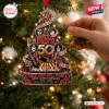 Close-up of a decorative Kiss Rock Band 50th Anniversary Ornament hanging on a lit Christmas tree.