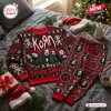 Flat lay of Korn Red 2026 Christmas Sweater and Jogger Set with band portraits and holiday motifs on a grey bed.
