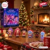 Front view of Kpop Star Guardians Advent Calendar 2026 box with six figurines placed on a wooden table near a fireplace.