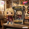 Front view of the Kurt Cobain Nirvana 40th Anniversary Vinyl Figure standing beside its boxed packaging.