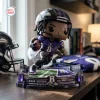 Front view of Lamar Jackson Baltimore Ravens vinyl figurine on a football field base holding a football.