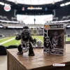 Front view of the Las Vegas Raiders Gorilla Rilla Vinyl Figure displayed with its box on a wooden table.
