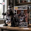 Front view of the Las Vegas Raiders Gorilla Rilla Vinyl Figure alongside its decorated packaging box on a wooden table.