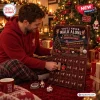 Man opening door number nine of the Liverpool FC Christmas Advent Calendar in a festive room.