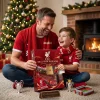 Father and son opening the Liverpool Football Club 2026 Advent Calendar by a Christmas tree.