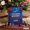 Front view of Los Angeles Dodgers 2026 Advent Calendar box under tree with baseball items.