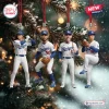 Four baseball player figurines hanging as ornaments against a decorated pine tree background.