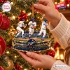 Closeup of hands hanging Los Angeles Dodgers Kirk Gibson Walk Off Home Run Ornament on a tree.