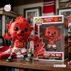 Front view of the Manchester United Fred The Red vinyl figure standing next to its branded box.