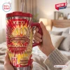 Hand holding McDonald's 86th Anniversary YETI Handle Tumbler in a bedroom setting.