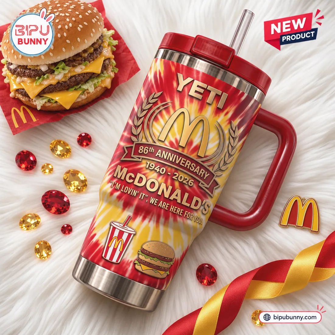 McDonald's 86th Anniversary YETI Handle Tumbler flat-lay on white fur beside a double-decker sesame burger and Golden Arches pin