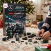 Front view of Mercedes-AMG Petronas Formula 1 Team Christmas Advent Calendar box with toy pieces displayed on a floor.