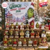 Front view of Merry Christmas The Grinch Advent Calendar 2026 box with twenty-four numbered figurines displayed on a wooden stand.