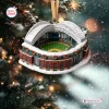 Front view of a stadium ornament featuring snowy details and hanging on a tree.