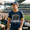 Fan wearing a Milwaukee Brewers 2026 Champions Shirt at a packed baseball stadium.