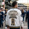 Back view of a person wearing the Milwaukee Brewers 2026 Champions White Bomber Jacket at a stadium.
