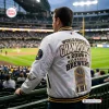 Back view of the Milwaukee Brewers 2026 Champions White Bomber Jacket worn at a baseball stadium.
