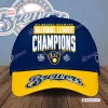 Front view of a blue Milwaukee Brewers snapback cap with yellow brim and champions text.