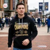 Front view of a man wearing a black Milwaukee Brewers 2026 World Series hoodie outside a stadium.