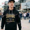 Man wearing Milwaukee Brewers 2026 World Series Black Hoodie at stadium.