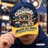 Closeup of a Milwaukee Brewers 2026 World Series Champions Baseball Cap with yellow brim and broom graphics.