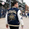 Rear view of a man wearing a blue and white baseball jacket with World Series Champions graphics.